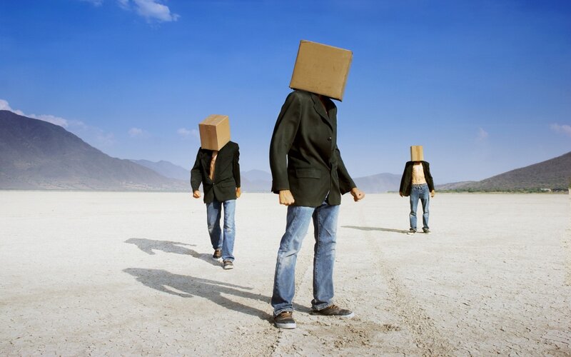 Three People with Boxes on Heads