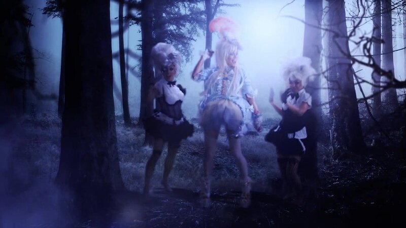 Three performers in a forest