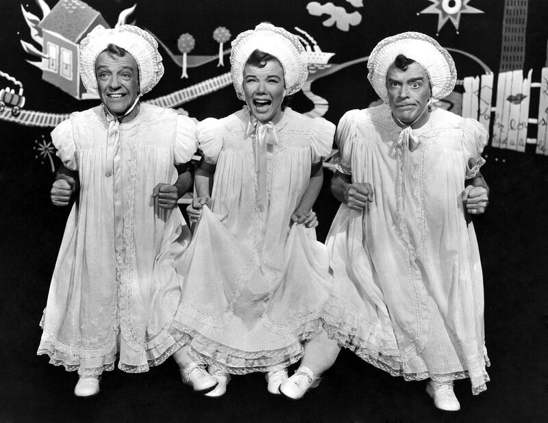 Three performers in baby costumes