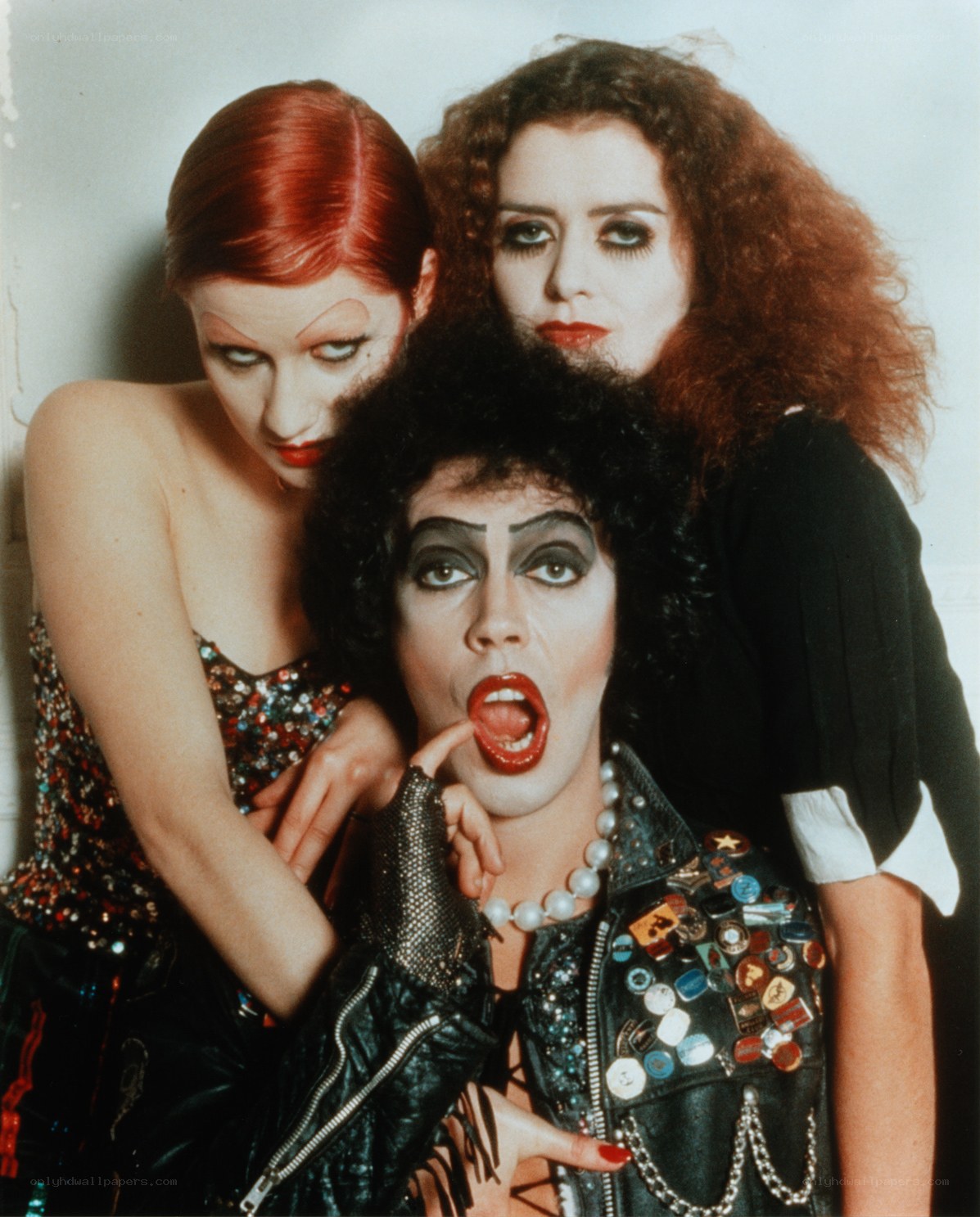 Three performers in theatrical makeup