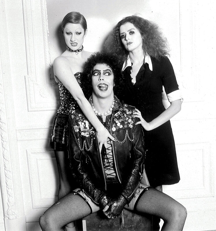 Three performers in theatrical makeup