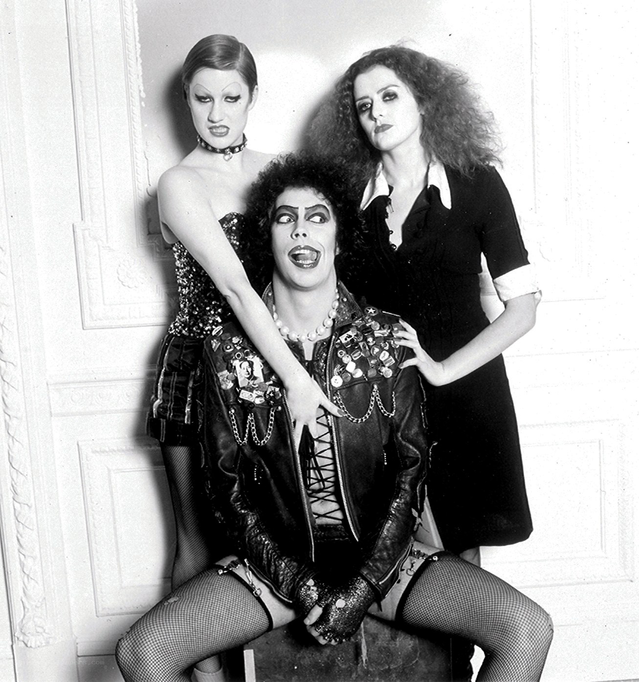 Three performers in theatrical makeup