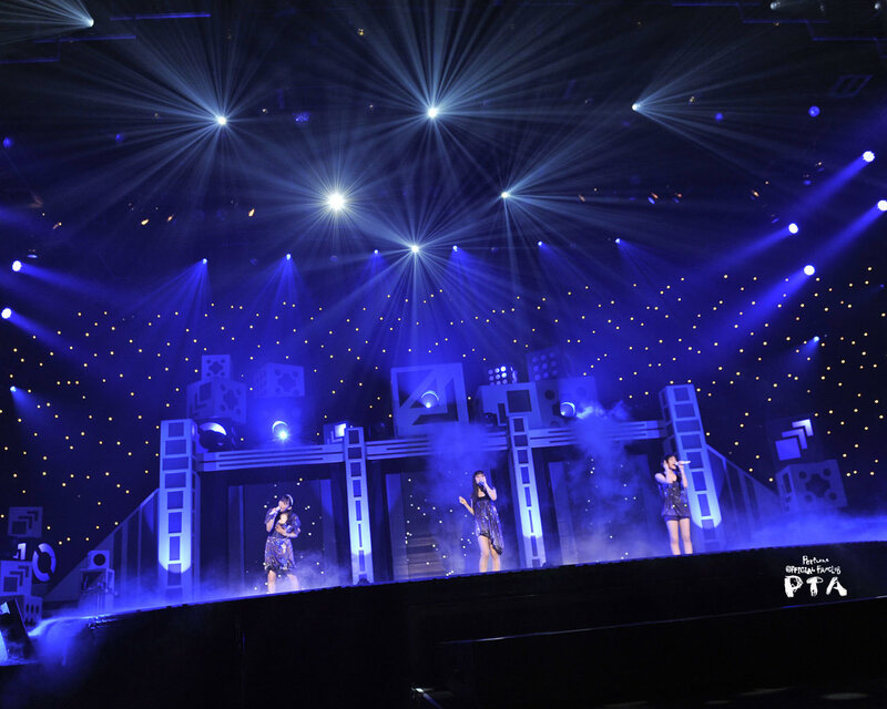 Three performers on a stage