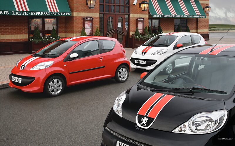 Three Peugeot 107 cars in red, white, and black