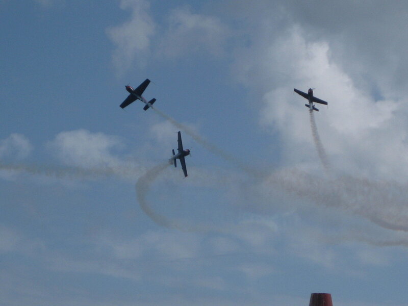 Three planes performing aerobatics
