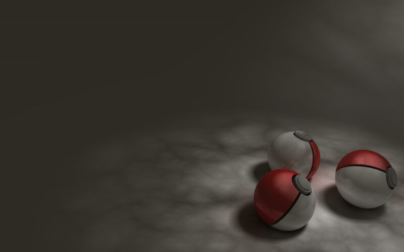 three pokeballs on dark surface
