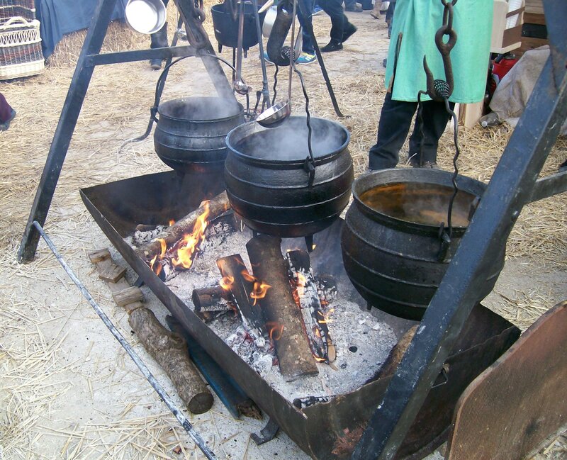 Three Pots Cooking over Fire