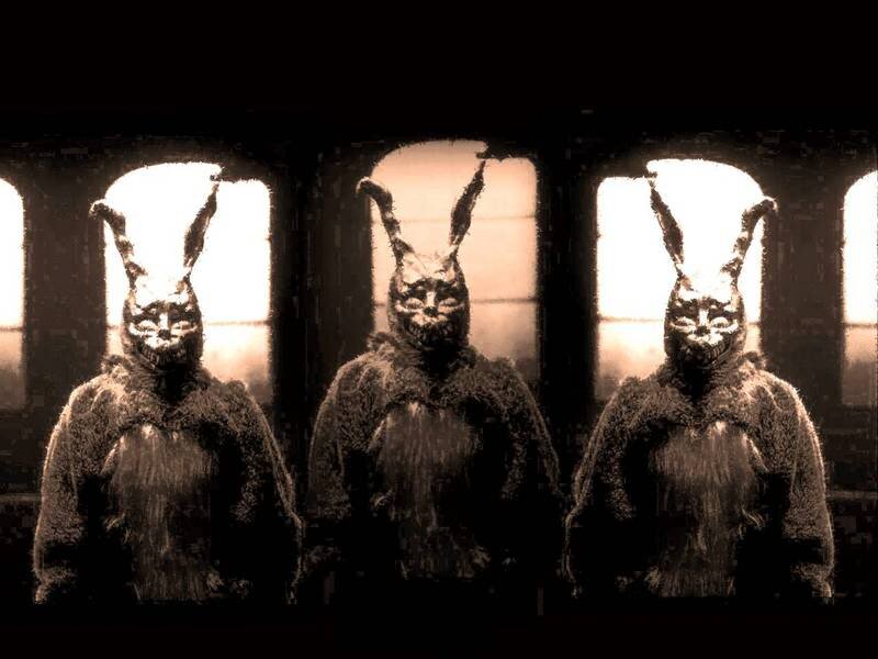 three rabbit figures in dark room