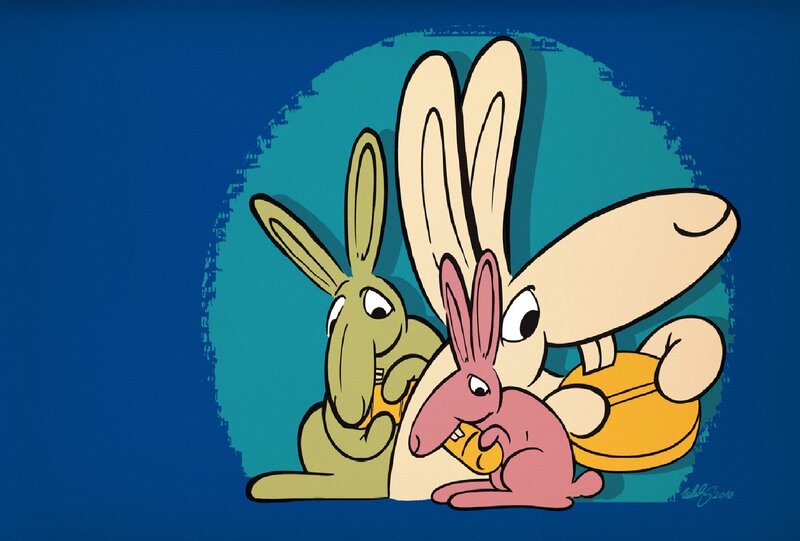three rabbits eating carrots