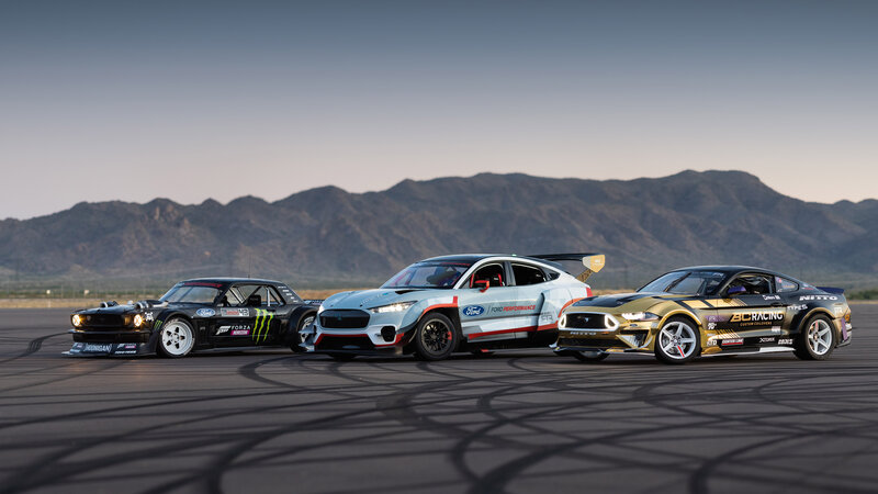 Three Race Cars on Track — Black, Dramatic