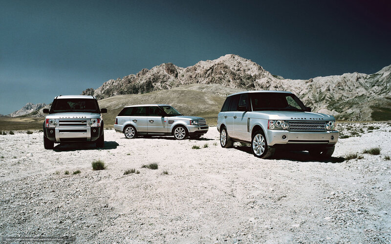 Three Range Rovers in desert