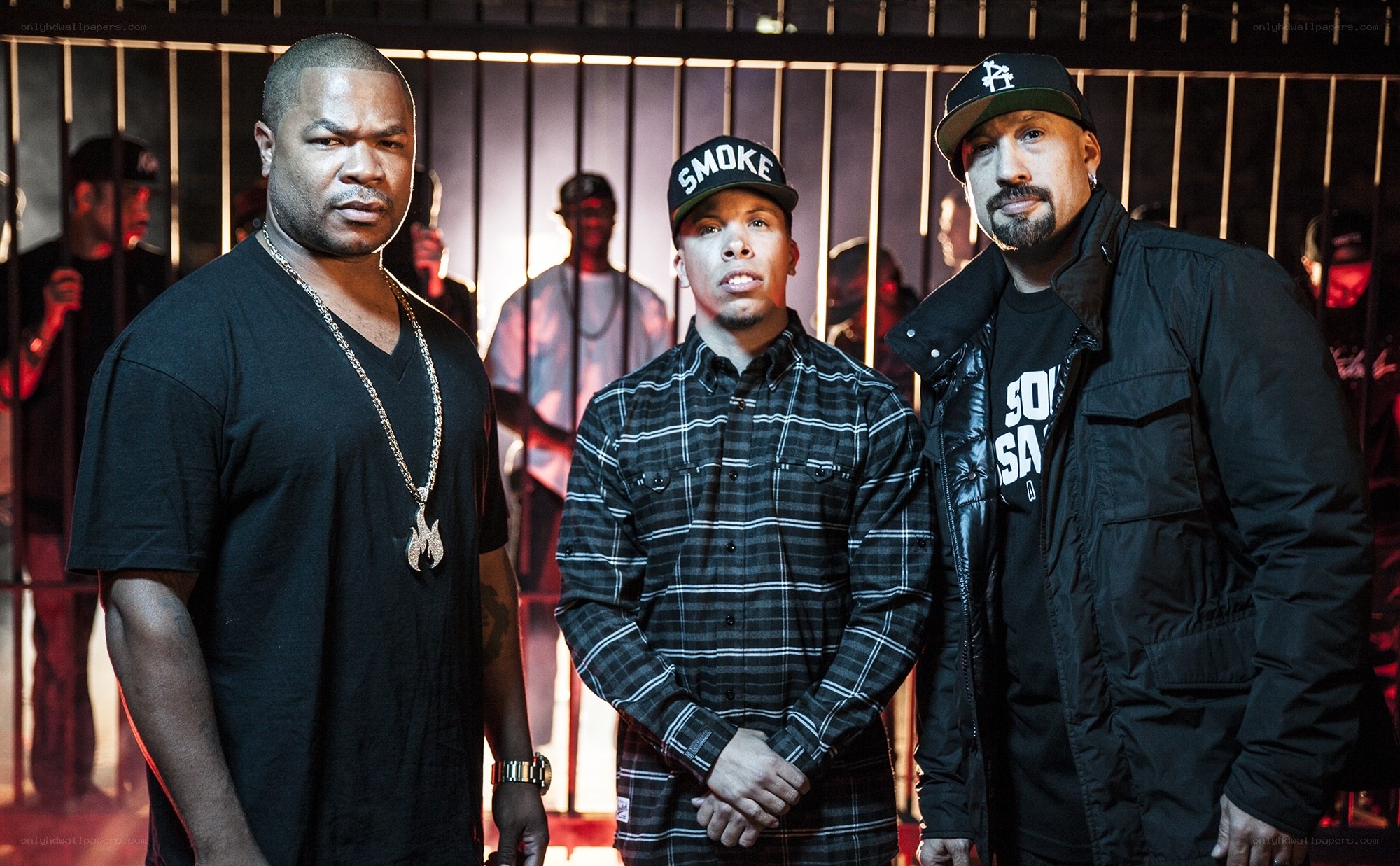 three rappers in front of bars