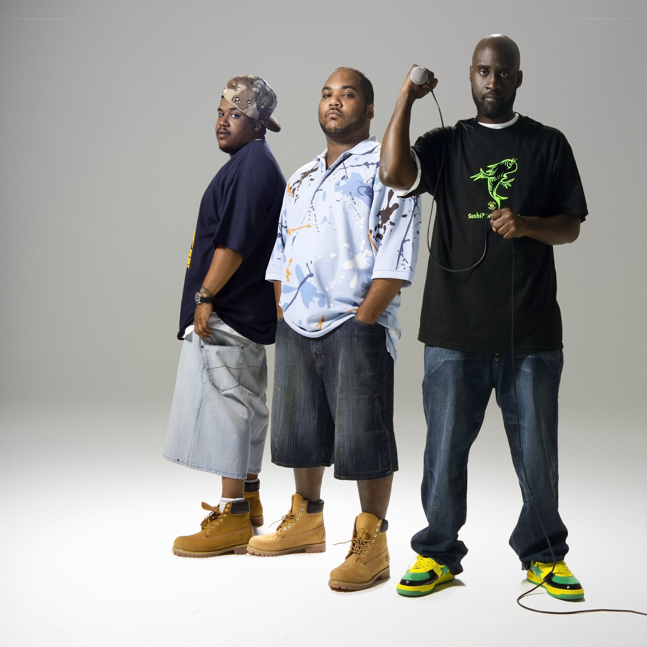 three rappers posing with microphone