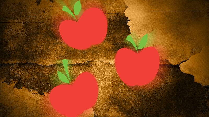 three red apples on textured background