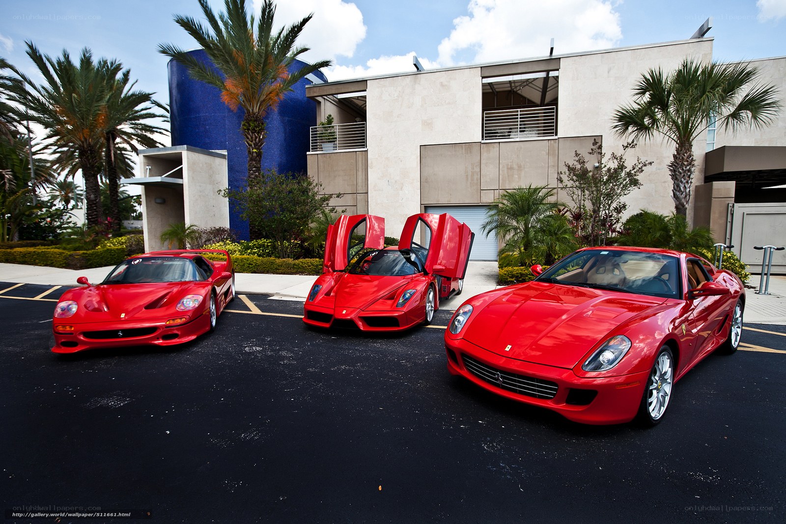 Three red Ferraris in a driveway