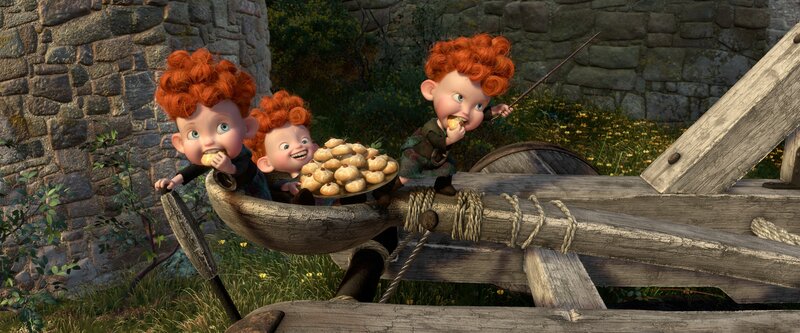 Three red-haired boys eating pastries