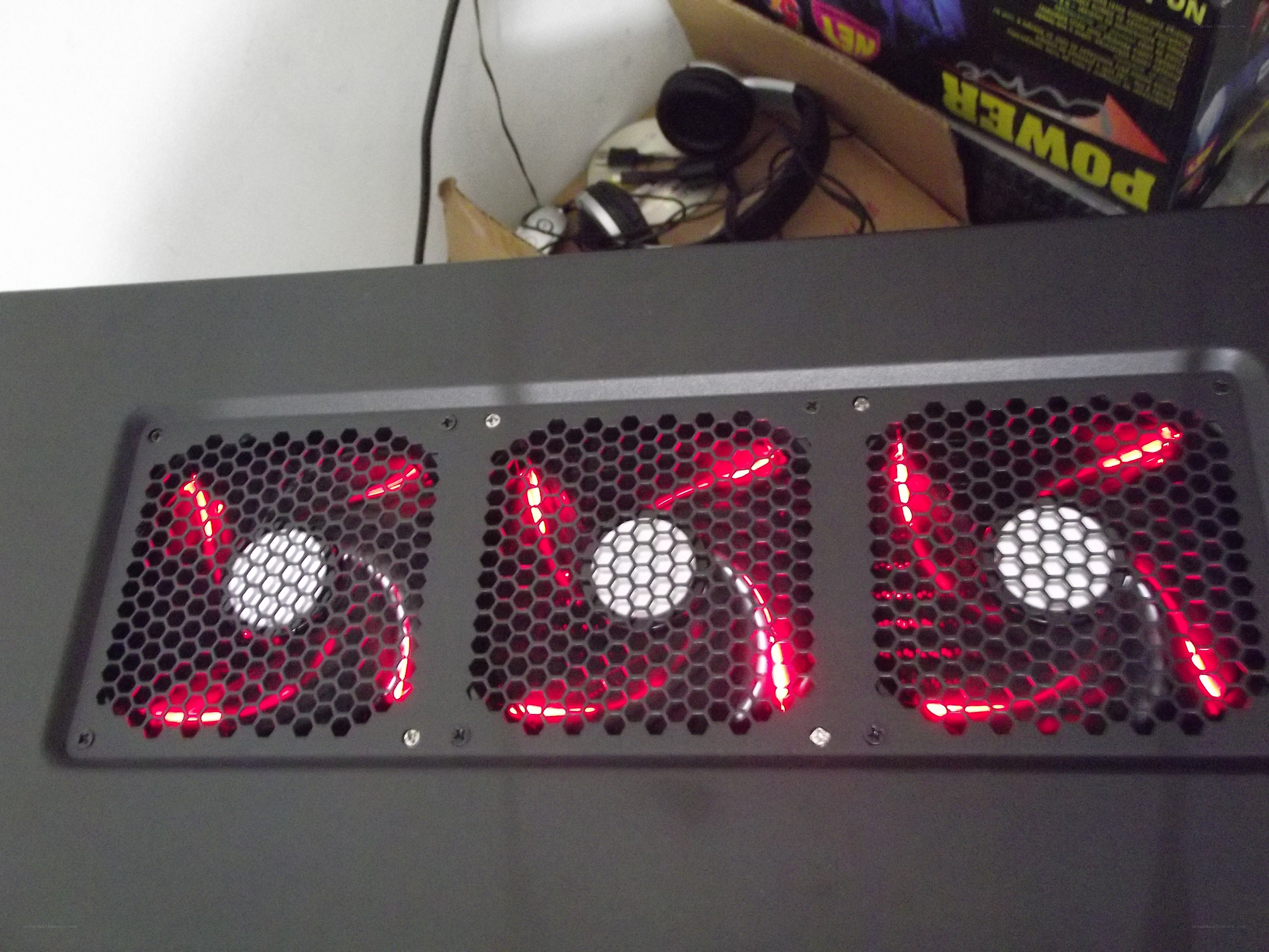 three red-lit fans on a PC case