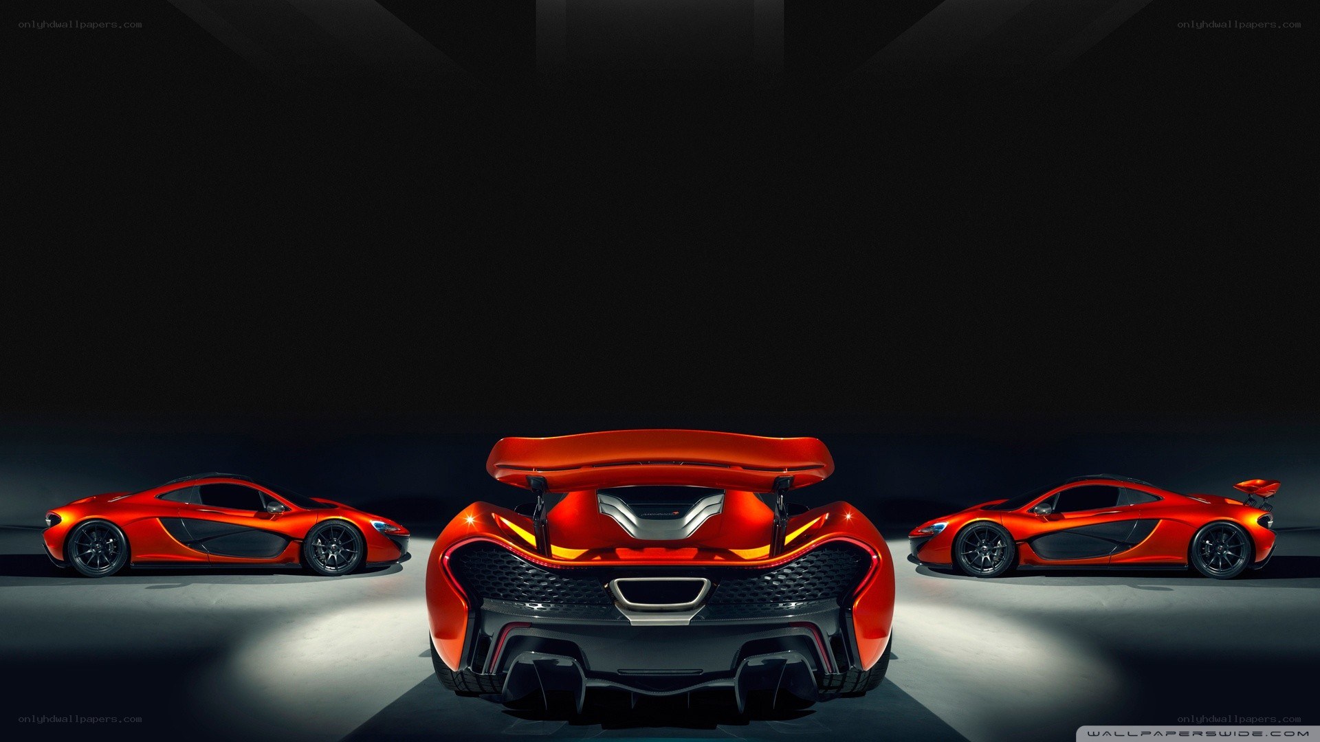 Three red McLaren P1 cars