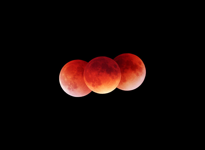 Three red moons in night sky