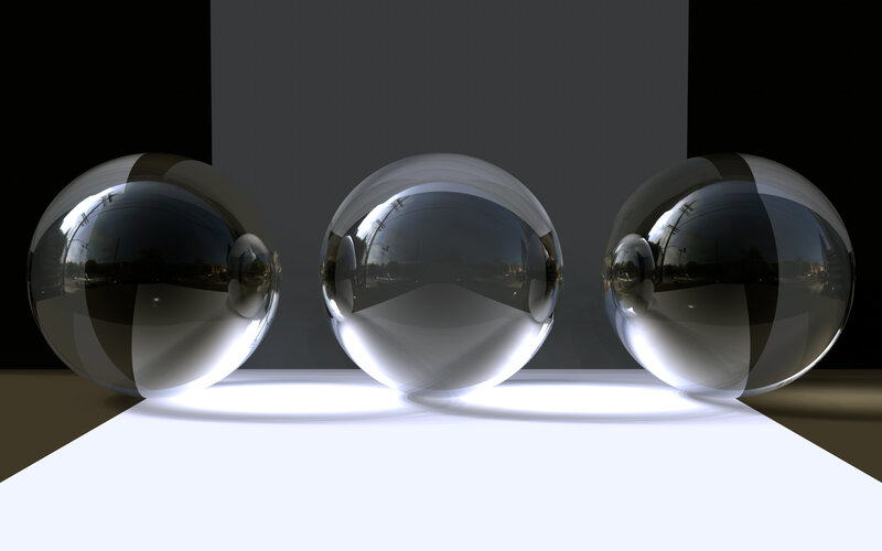 Three reflective spheres on white surface