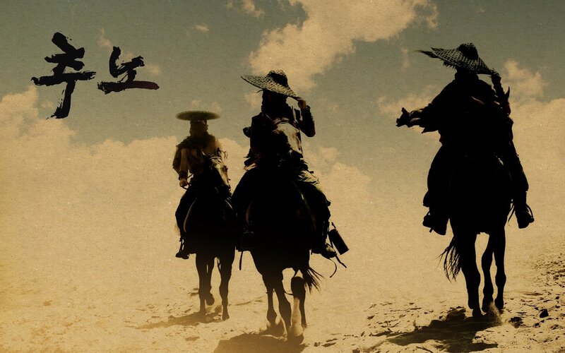 Three riders on horseback in desert