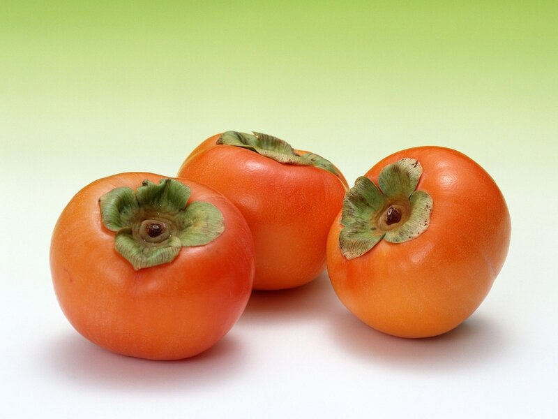 Three ripe persimmons