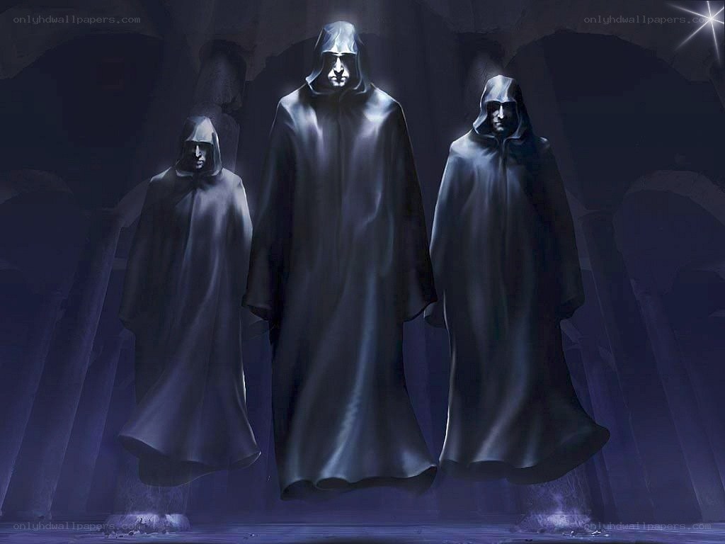 three robed figures in a cave