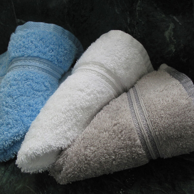 Three rolled towels on stone