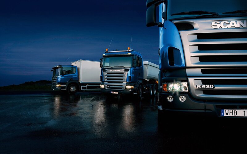 Three Scania trucks at night