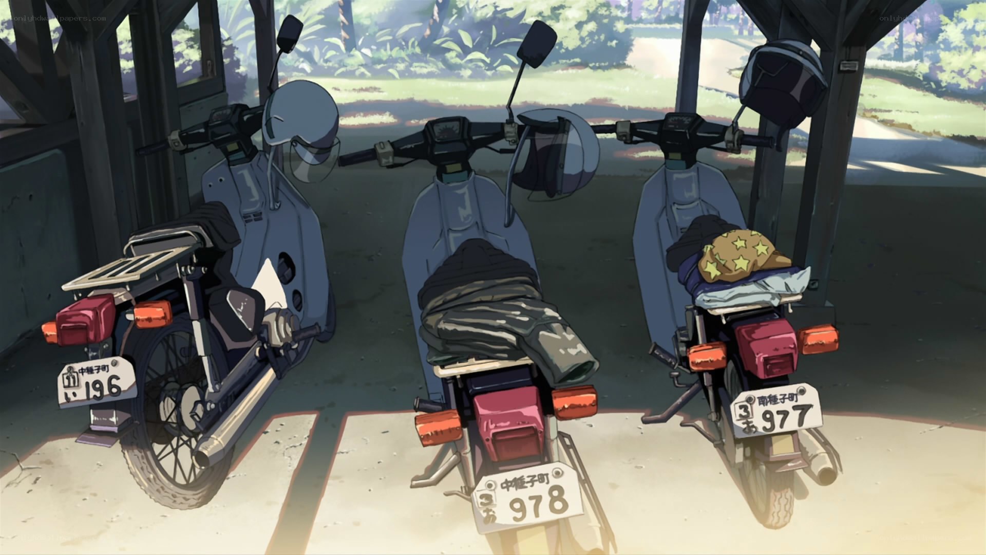 Three scooters in a shelter