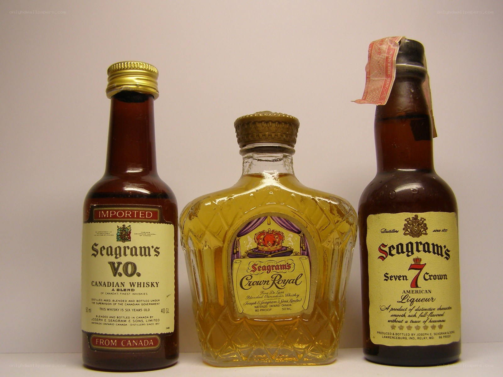 Three Seagram's whisky bottles