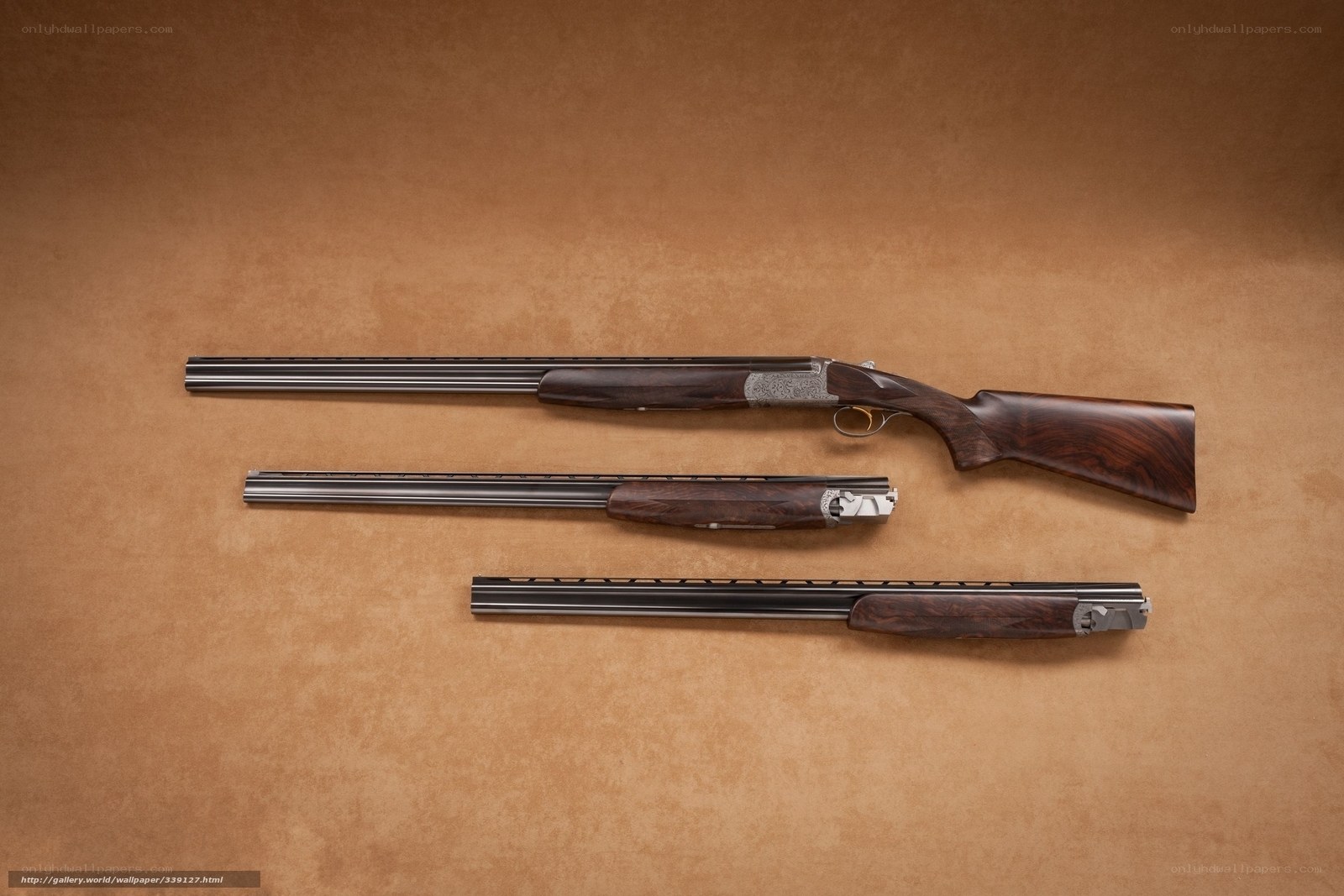 three shotguns on brown surface