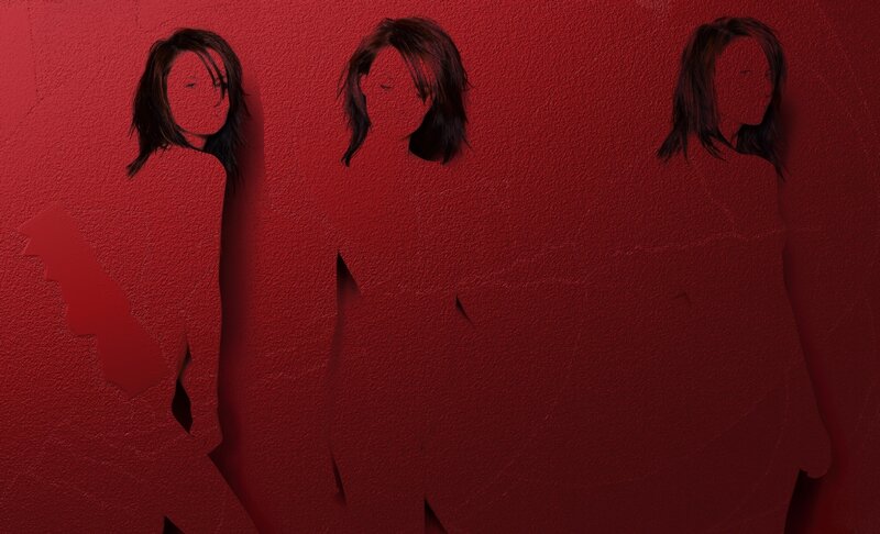Three silhouettes on red wall