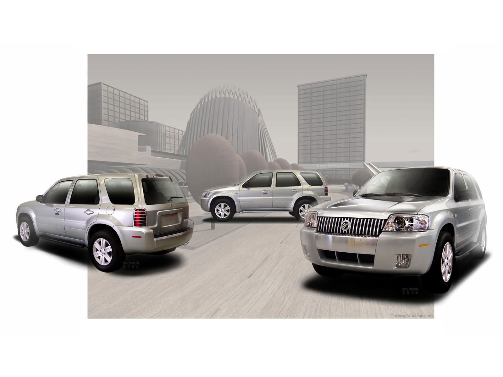 three silver SUVs in city