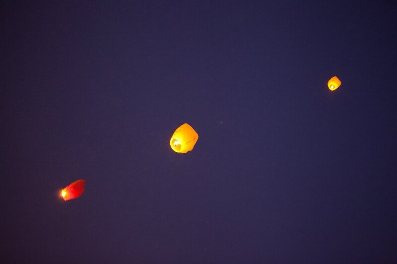 Three sky lanterns at night