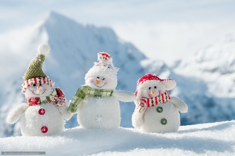 Three snowmen in snowy mountains