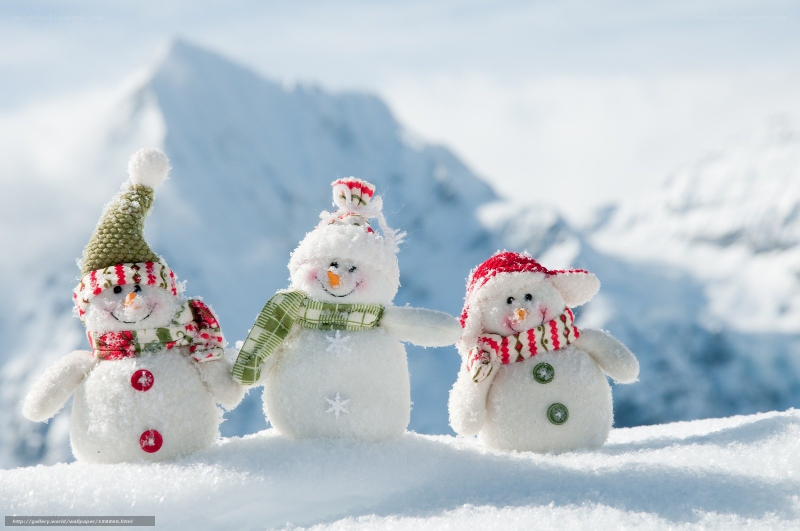 Three snowmen in snowy mountains