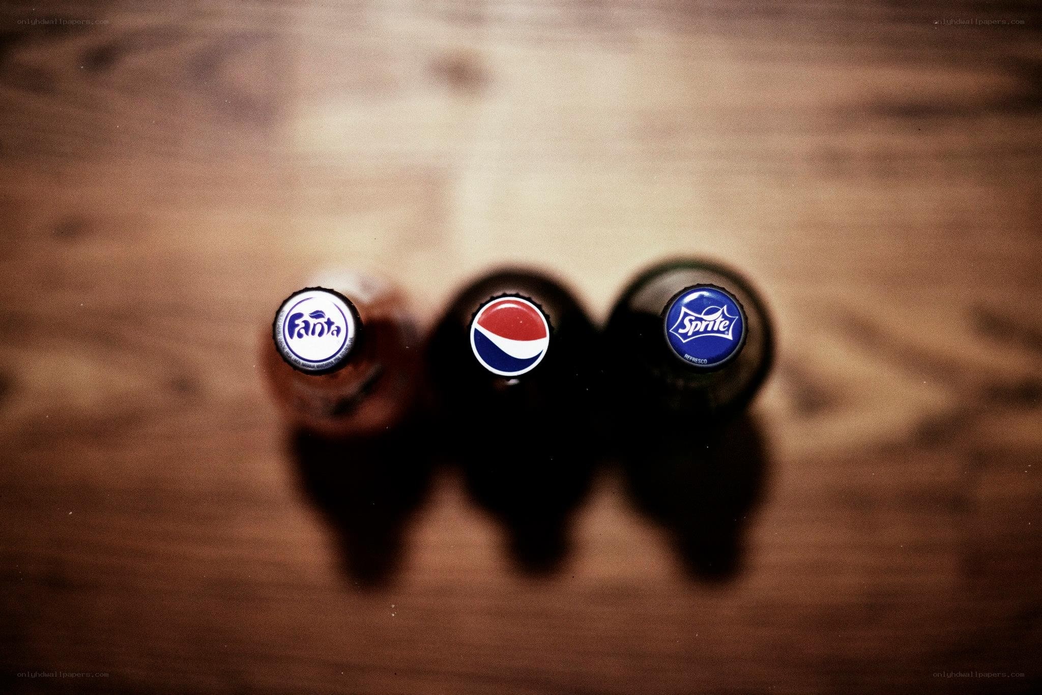 three soda bottles on wood