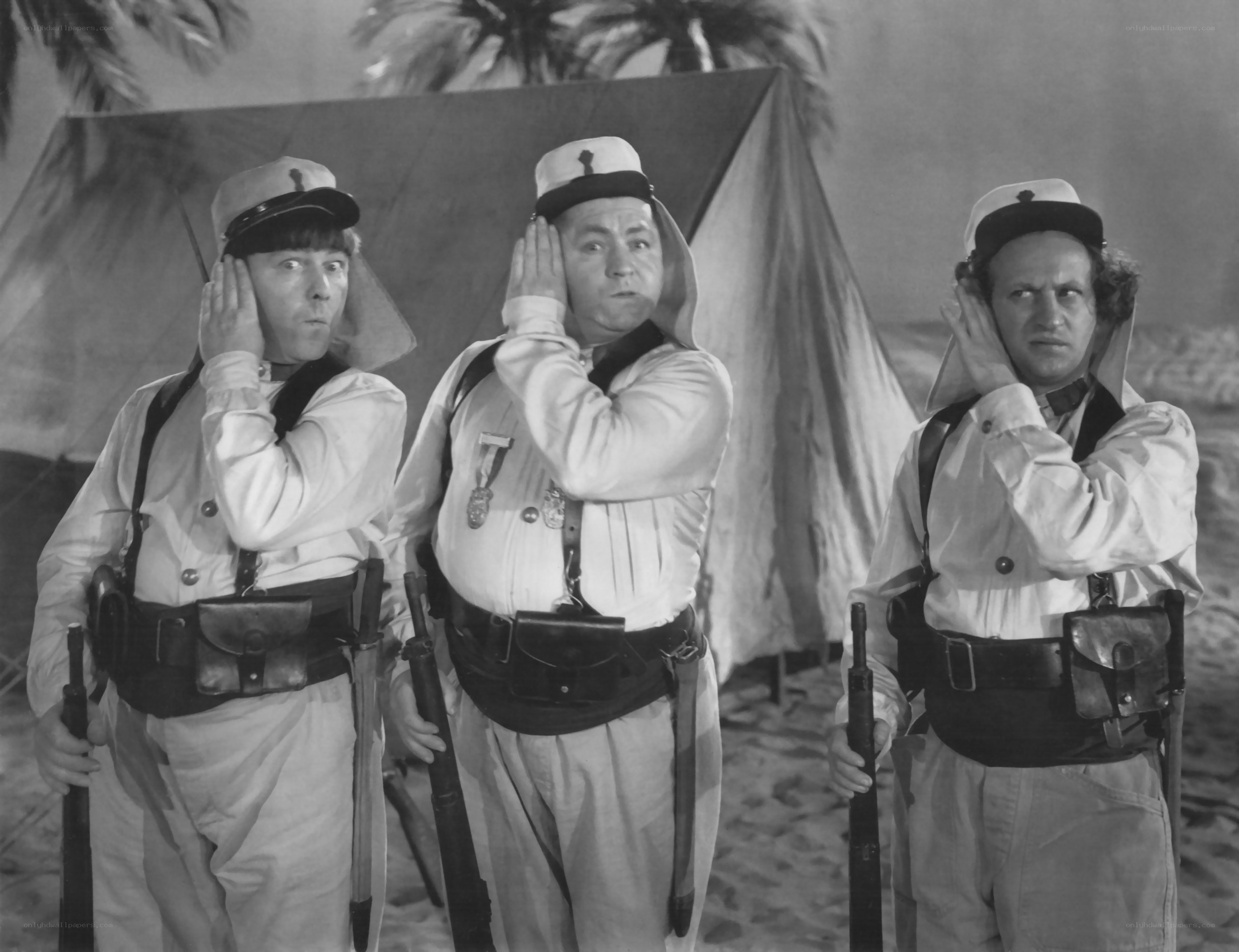 Three soldiers in desert uniform