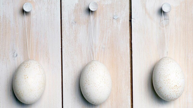 three speckled eggs hanging