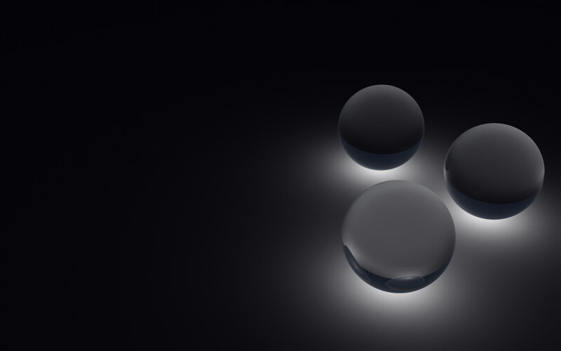 Three spheres on dark background