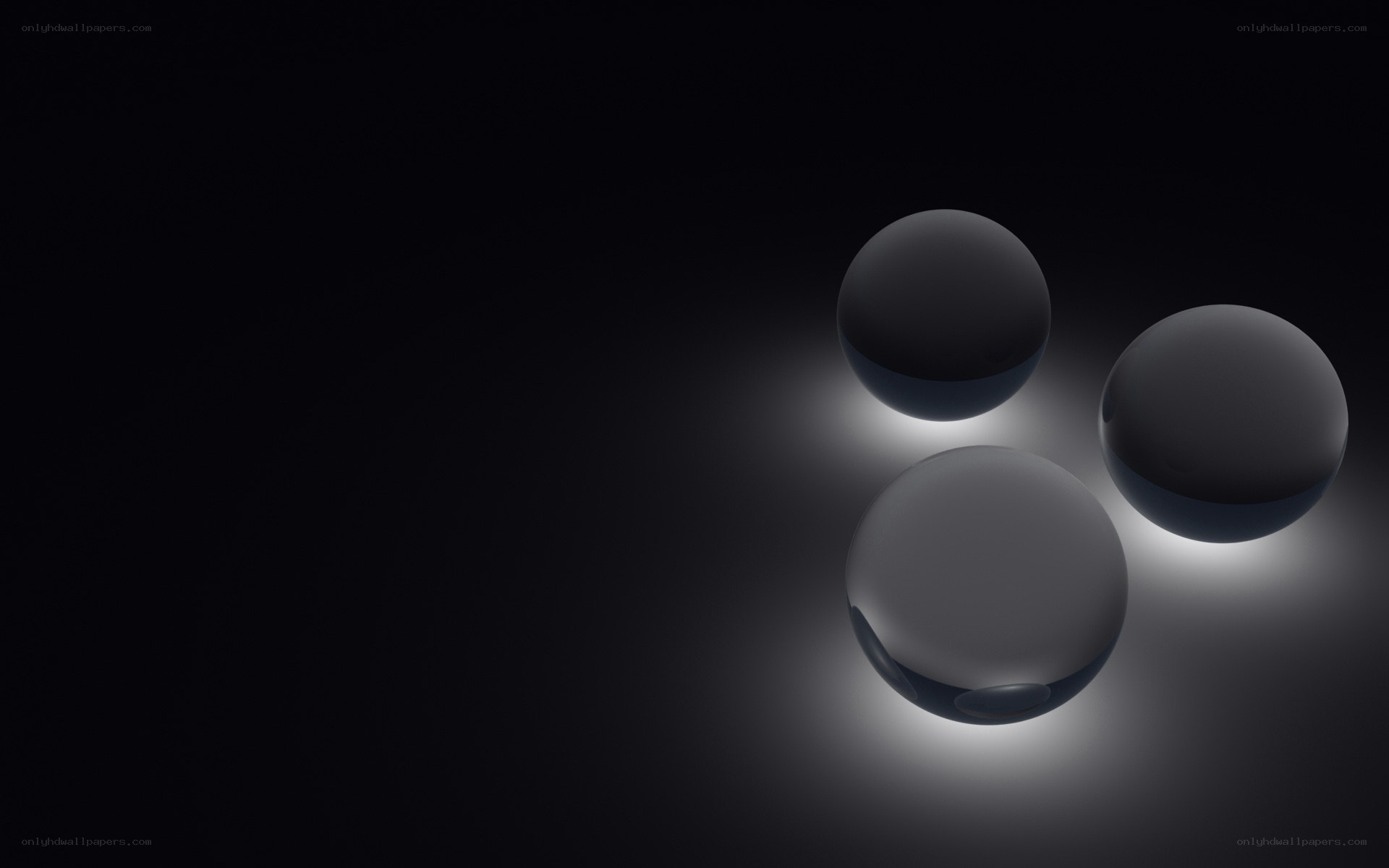 Three spheres on dark background