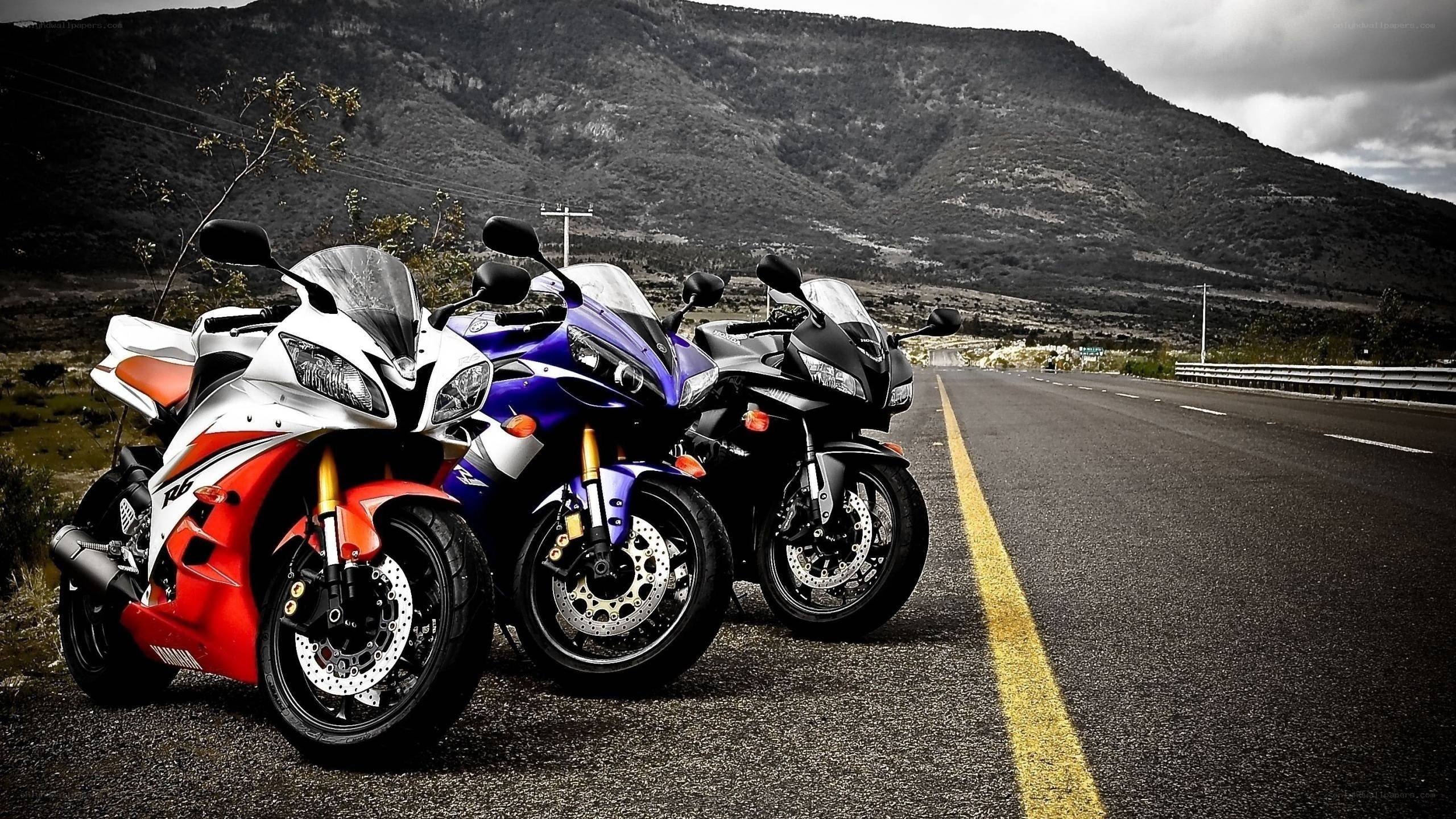 Three sport motorcycles on a road