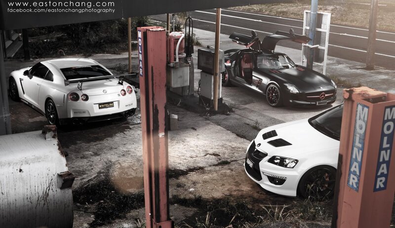 Three sports cars at a gas station