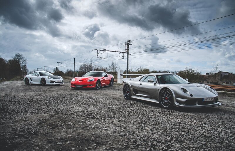 Three sports cars on gravel