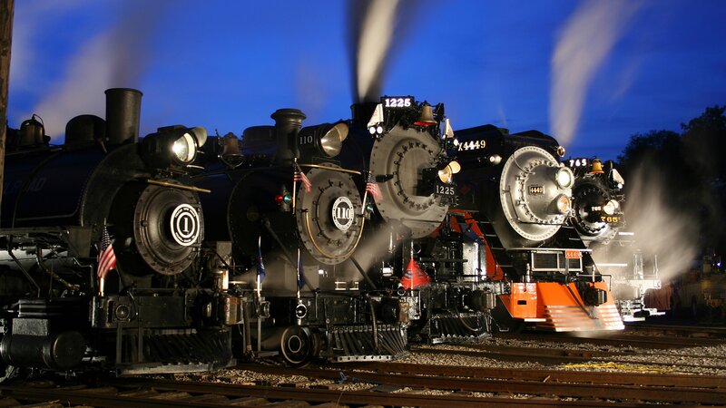 Three steam locomotives at night