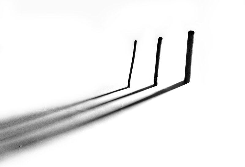 Three sticks casting shadows