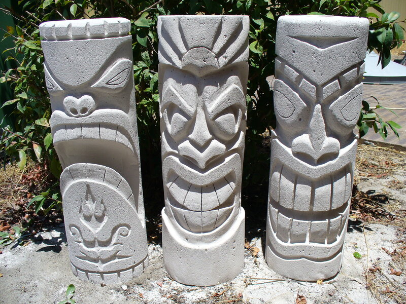 Three stone tiki statues
