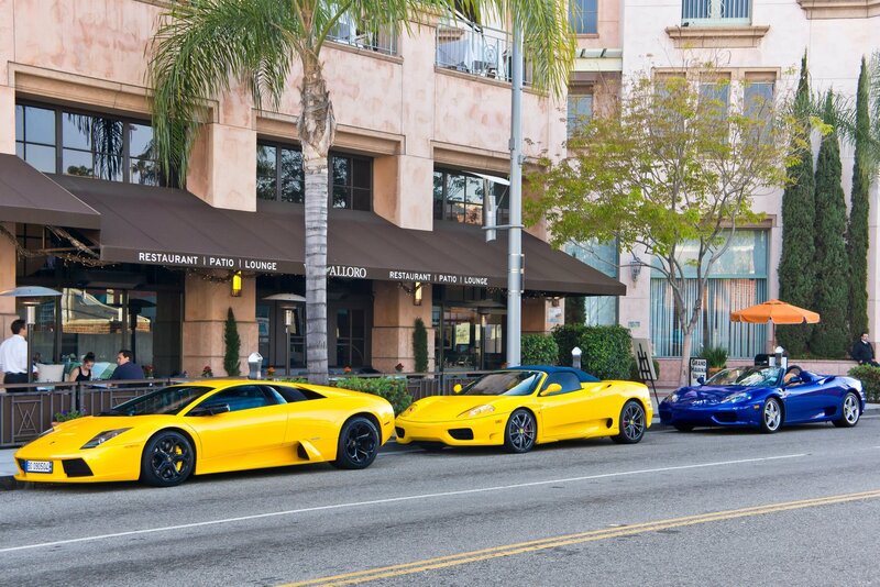 Three supercars parked on street