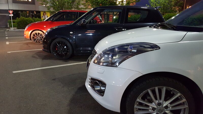 Three Suzuki Cars in Parking Lot